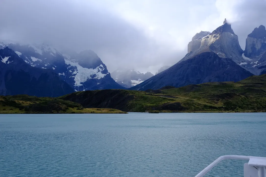 The Cuernos del Paine and the Paine Massif rising above the turquoise water of Lago Pehoé, photographed from the catamaran approaching Paine Grande.